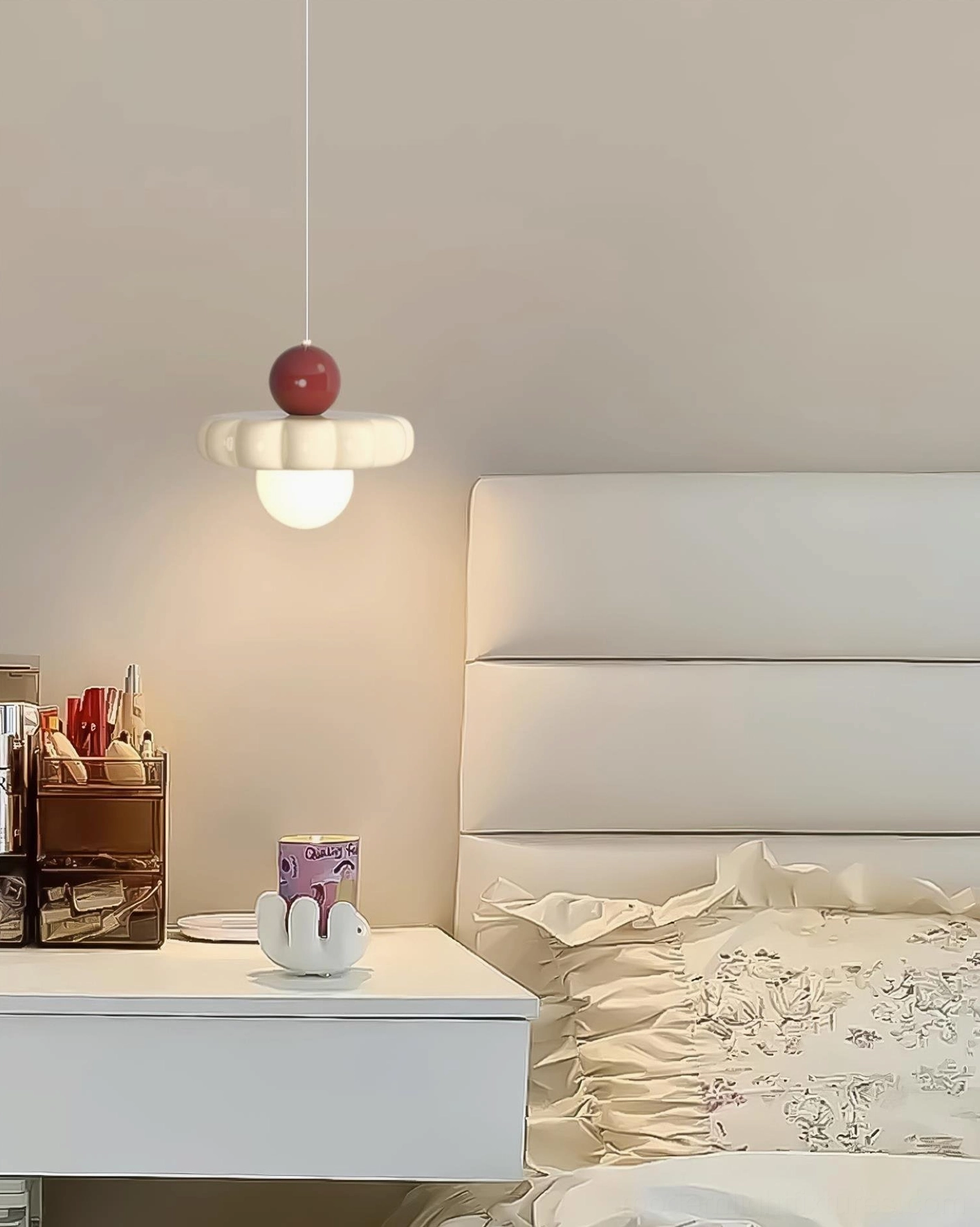 Celena cloud pendant light above white bedroom vanity, low-angle side view luxury lighting
