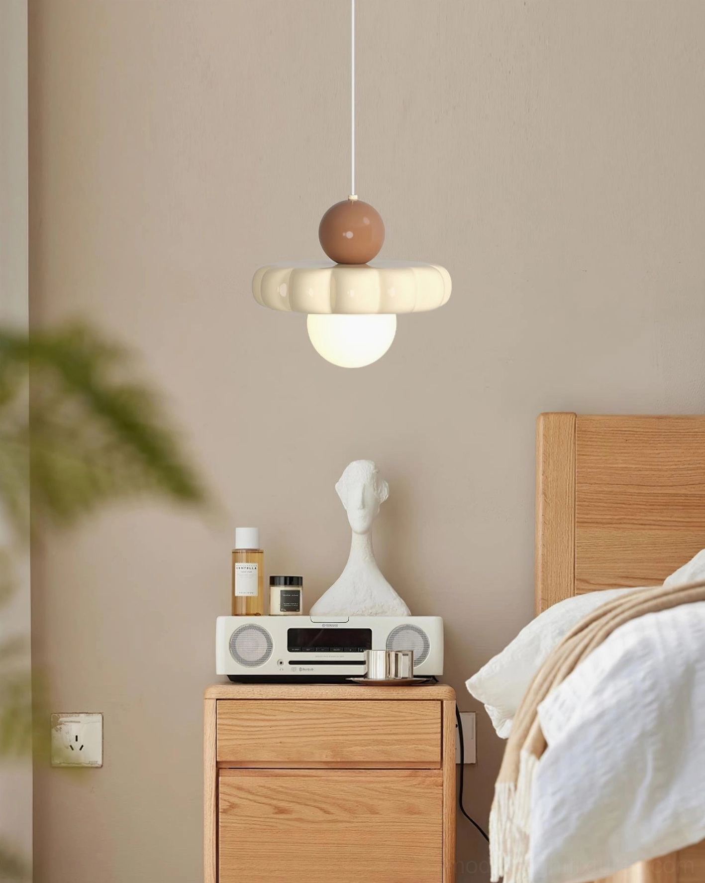 Celena pendant light beside wooden nightstand in bedroom, side wall-mounted view cozy lighting