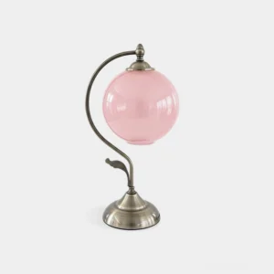 Celestial globe table lamp with curved brass arm and pink frosted glass sphere, front studio view highlighting vintage retro design