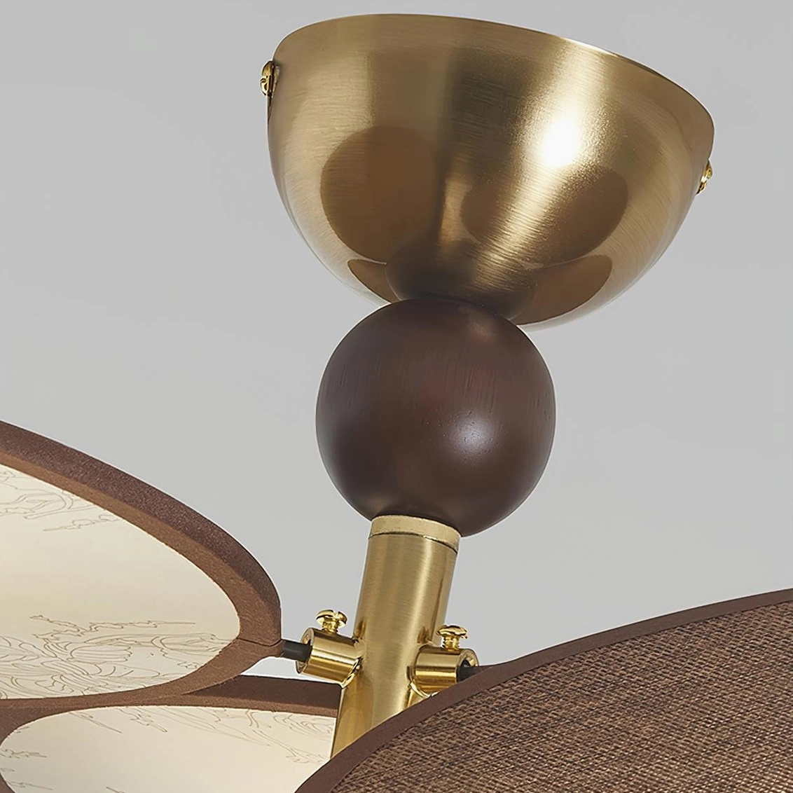 Celestial Spin decorative ceiling lamp close-up showing frosted glass sphere and metal canopy