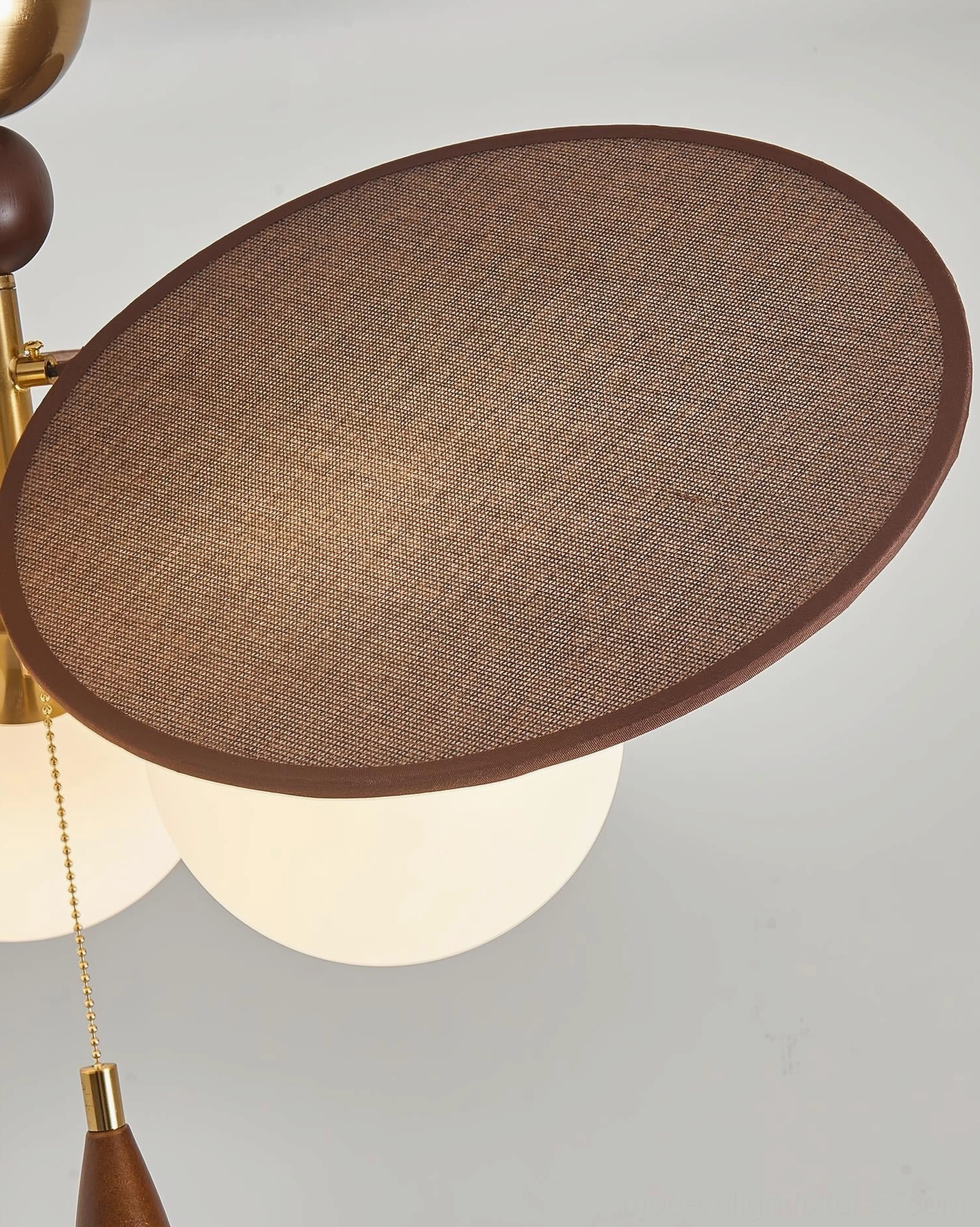 Three-light Celestial Spin ceiling fixture with brass hardware and wood accents detail