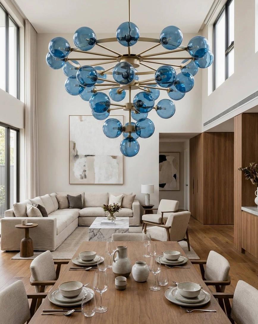 Celestine bubble chandelier in double-height dining living space with warm wood tones and neutral modern decor