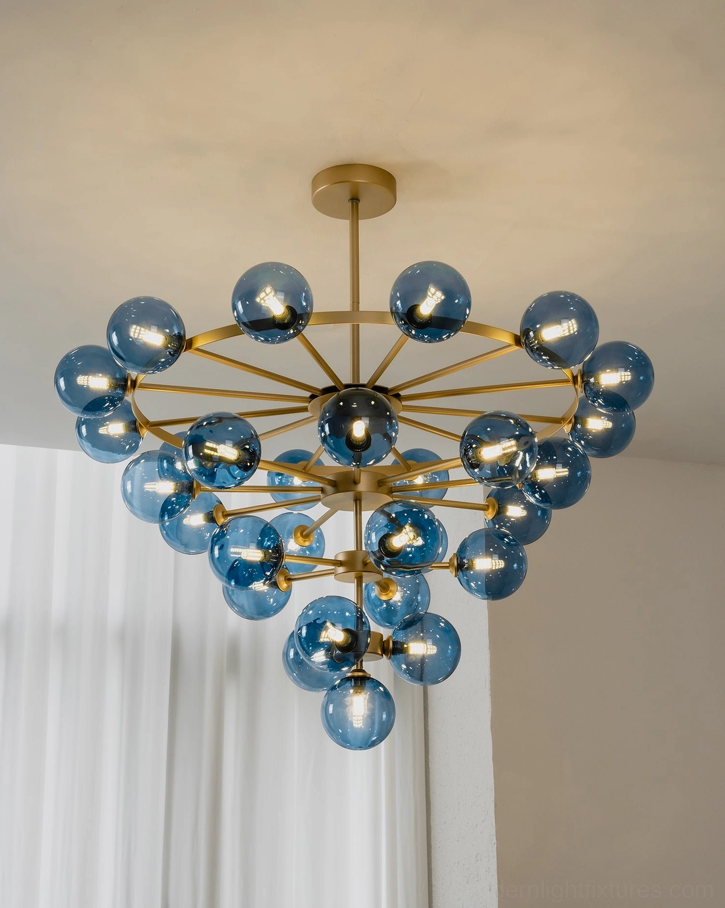 Celestine bubble chandelier close-up of glass globe texture and warm light filtering through cobalt-blue tinted glass