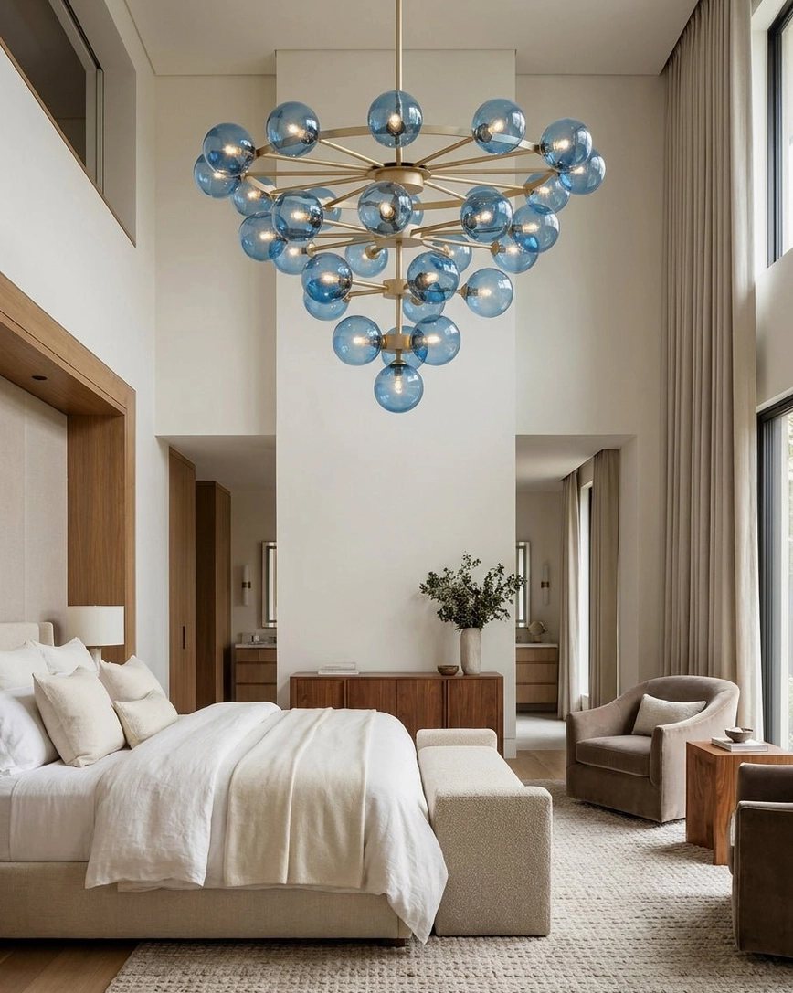 Celestine bubble chandelier hanging in luxury master bedroom with soft neutral modern styling and vaulted ceiling
