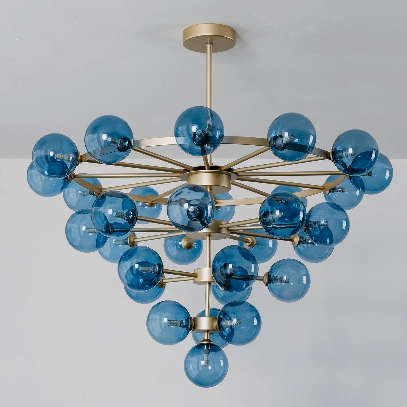 Celestine bubble chandelier overhead angled view showing radial sputnik structure with clustered blue glass orbs, studio background