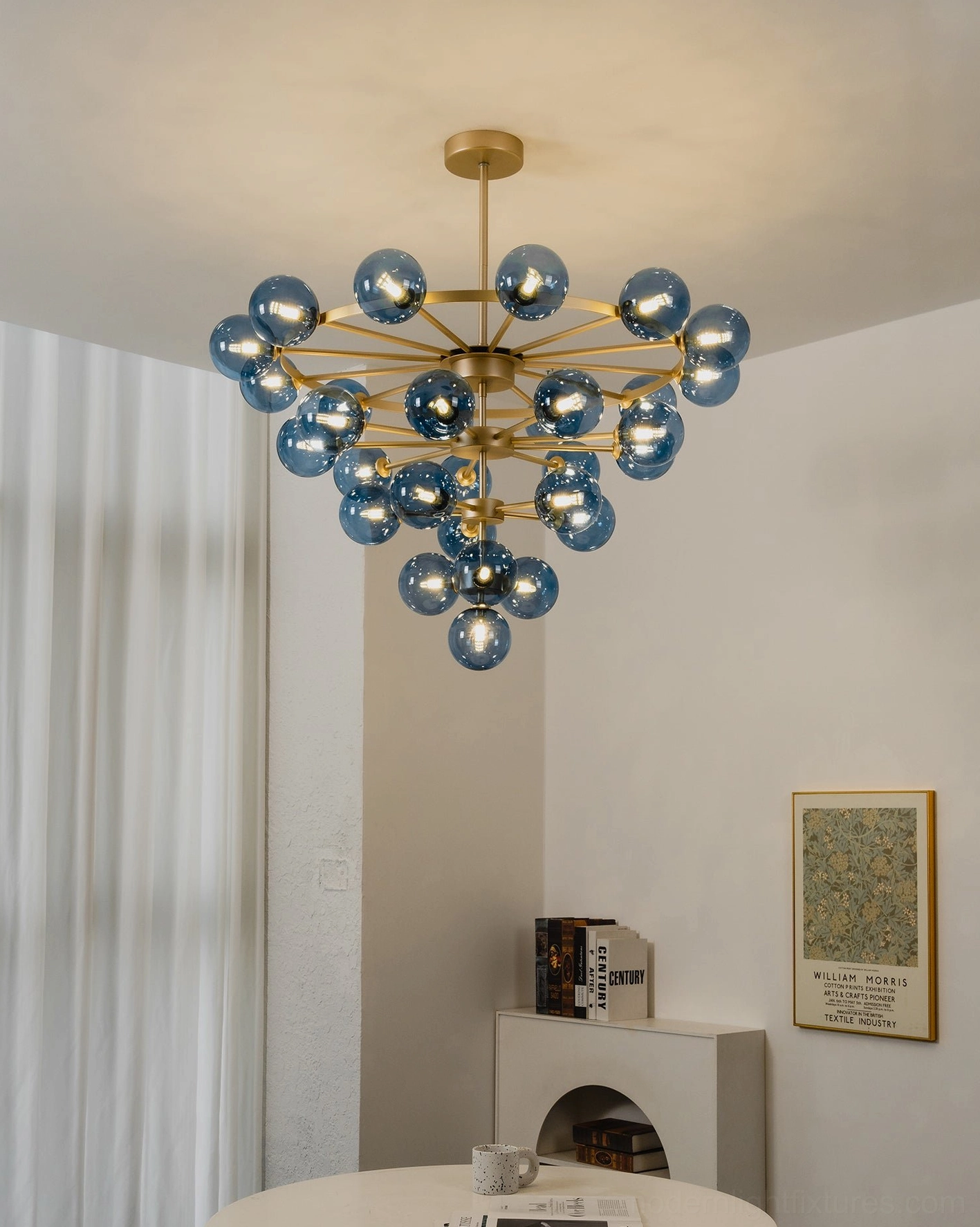 Celestine tiered bubble chandelier side profile showing cascading layers of blue glass spheres and brass frame structure