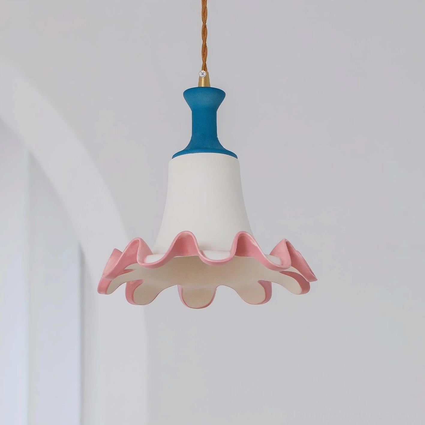 Celina handcrafted ceramic pendant light displayed in three-quarter side view within cottage-style archway setting