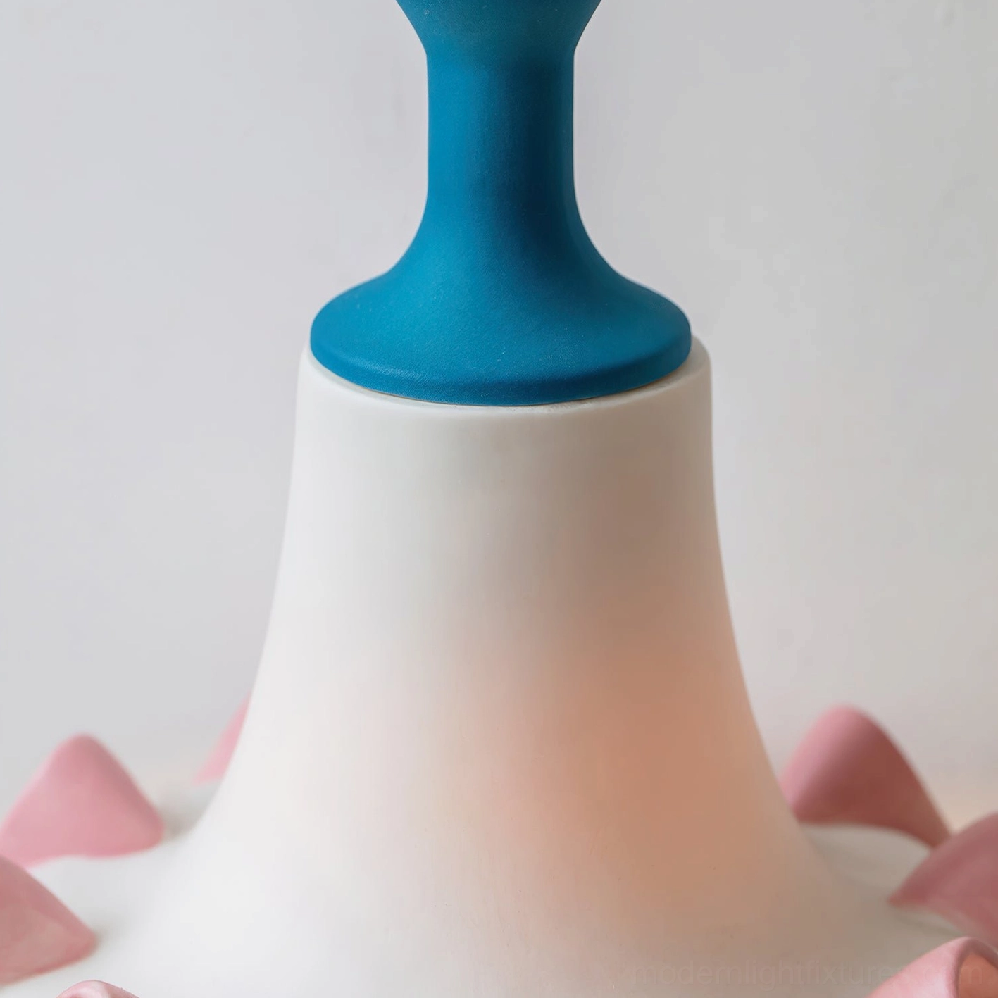 Celina lamp shade close-up top-down view highlighting blue ceramic crown, white body, and pink ruffled edge craftsmanship