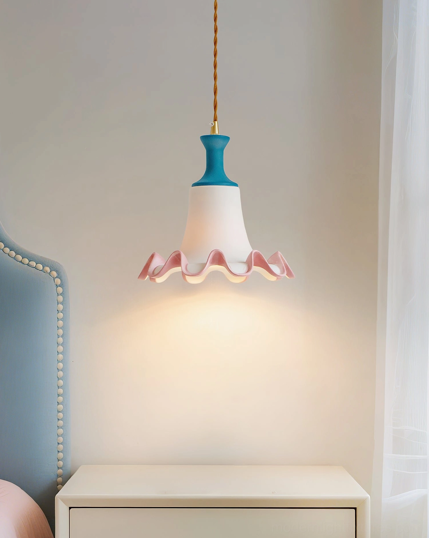 Celina ruffled pendant lamp hanging in modern bedroom providing warm ambient bedside lighting and sculptural accent