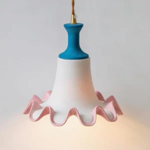 Close-up detail of Celina pendant lamp ruffled pink edge and white ceramic body with warm downward lighting effect