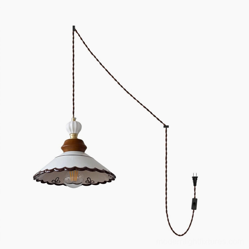Front view of Celine ceramic pendant shade with hand-painted brown trim and bow motifs in white studio setting