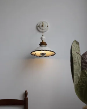 Vintage wall sconce with warm ambient glow in minimalist residential interior with green plant decor