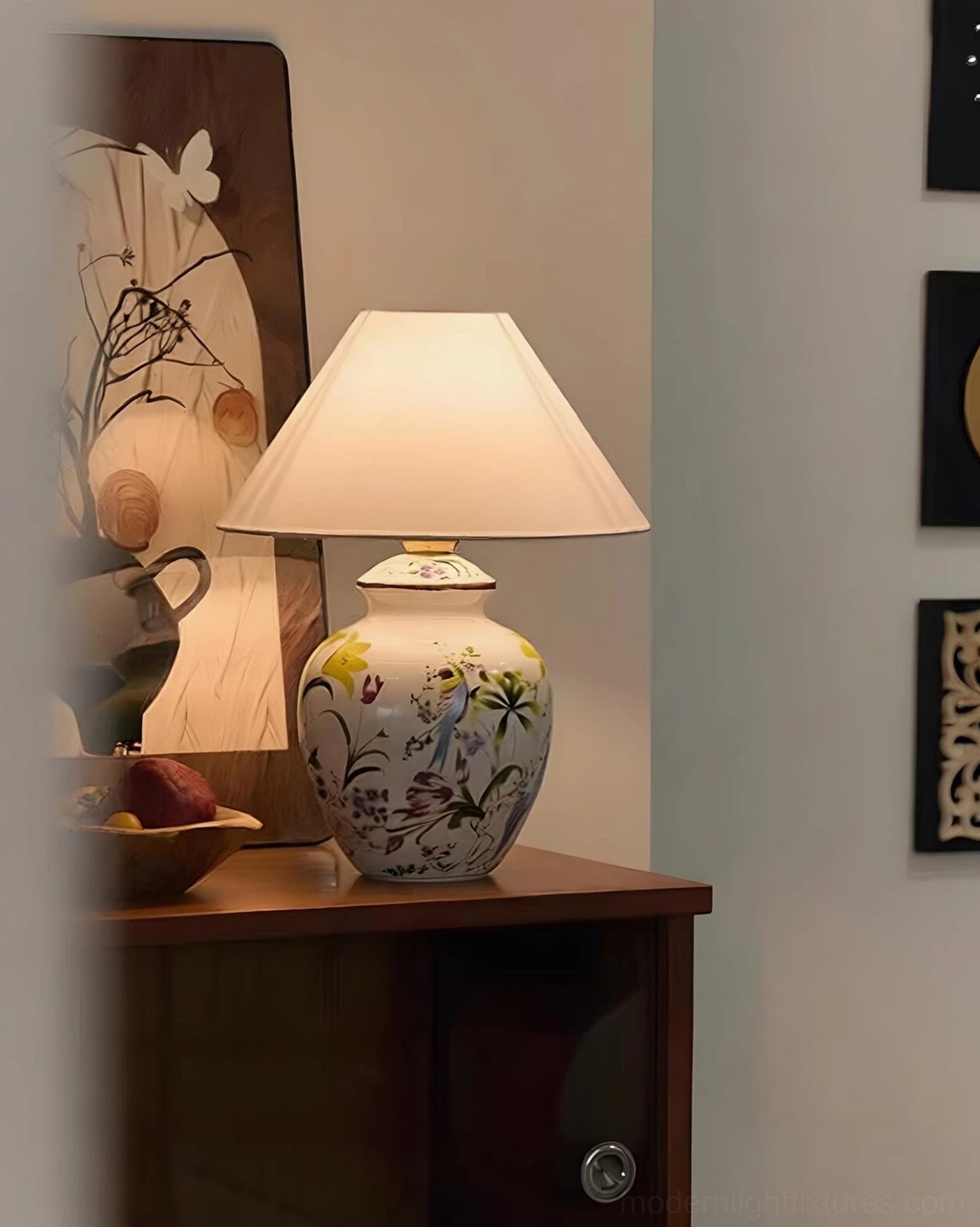 Hand-painted ceramic table lamp with off-white fabric shade on wooden nightstand, side profile bedroom scene