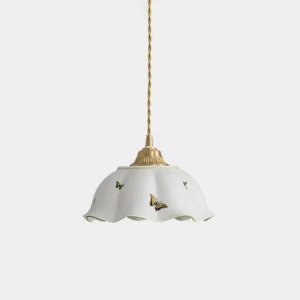 White ceramic pendant light with butterfly prints and brass hardware, front low-angle studio view