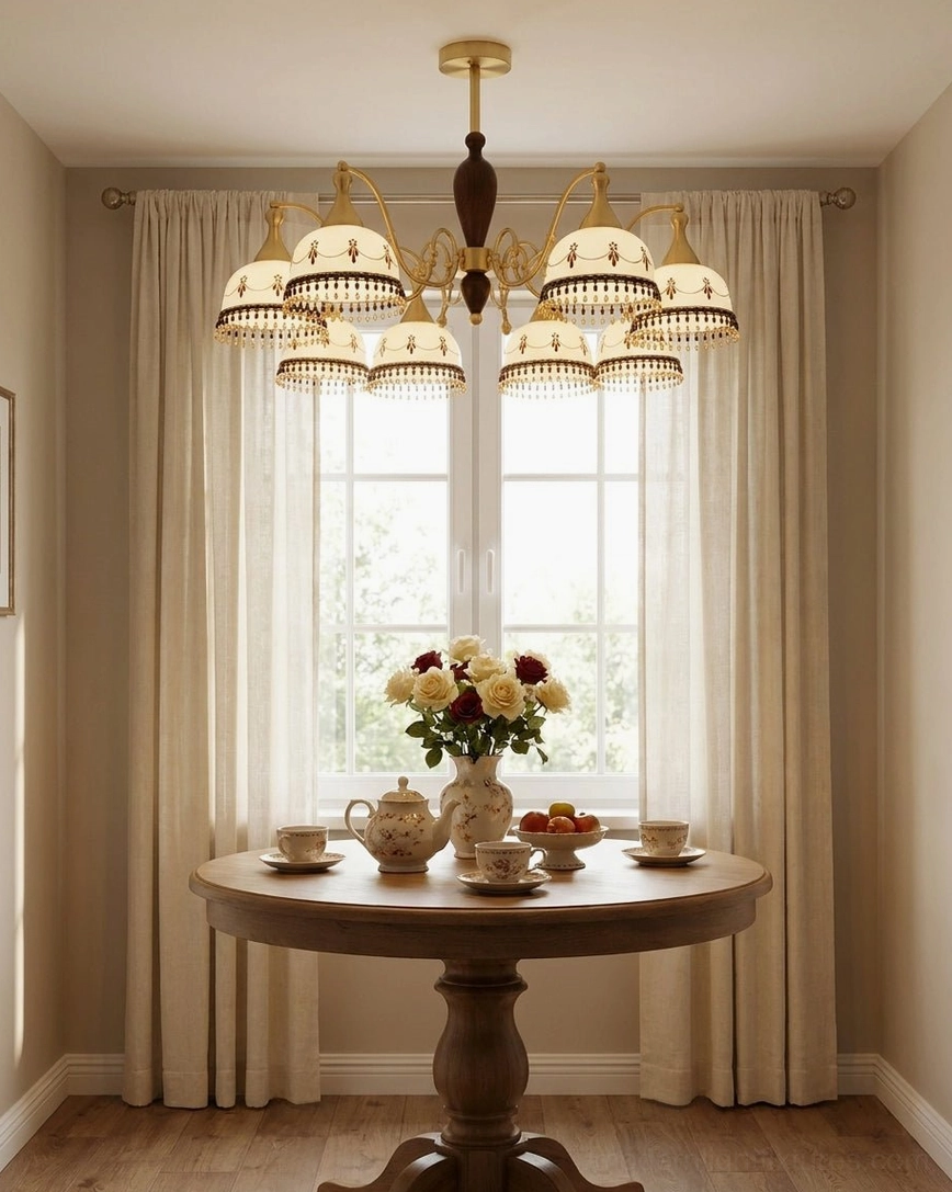 Vintage ceramic chandelier illuminating cozy farmhouse dining nook by window