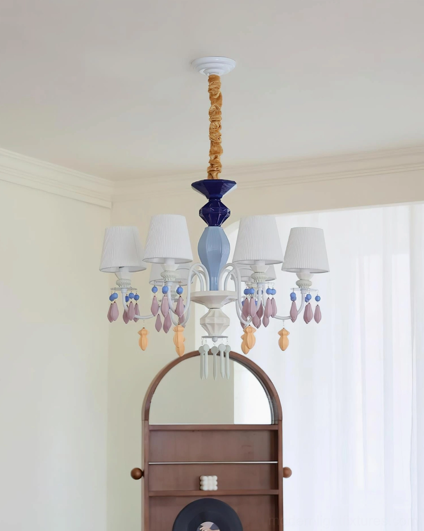 Detail view of ceramic chandelier frame showing metal construction and sculptural decorative elements