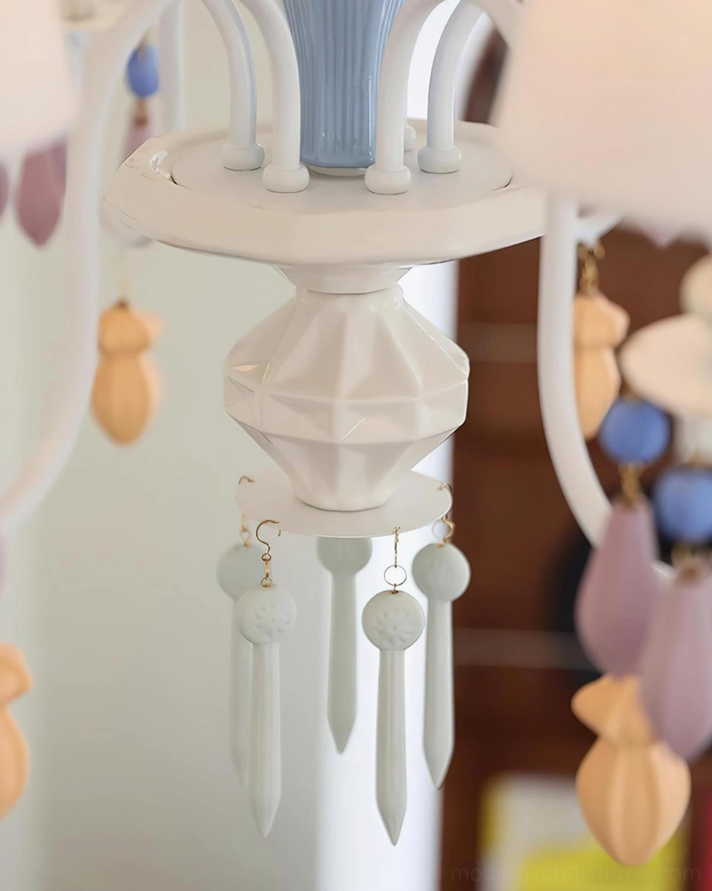 Installation view of modern ceramic multi-arm chandelier in residential interior with white walls