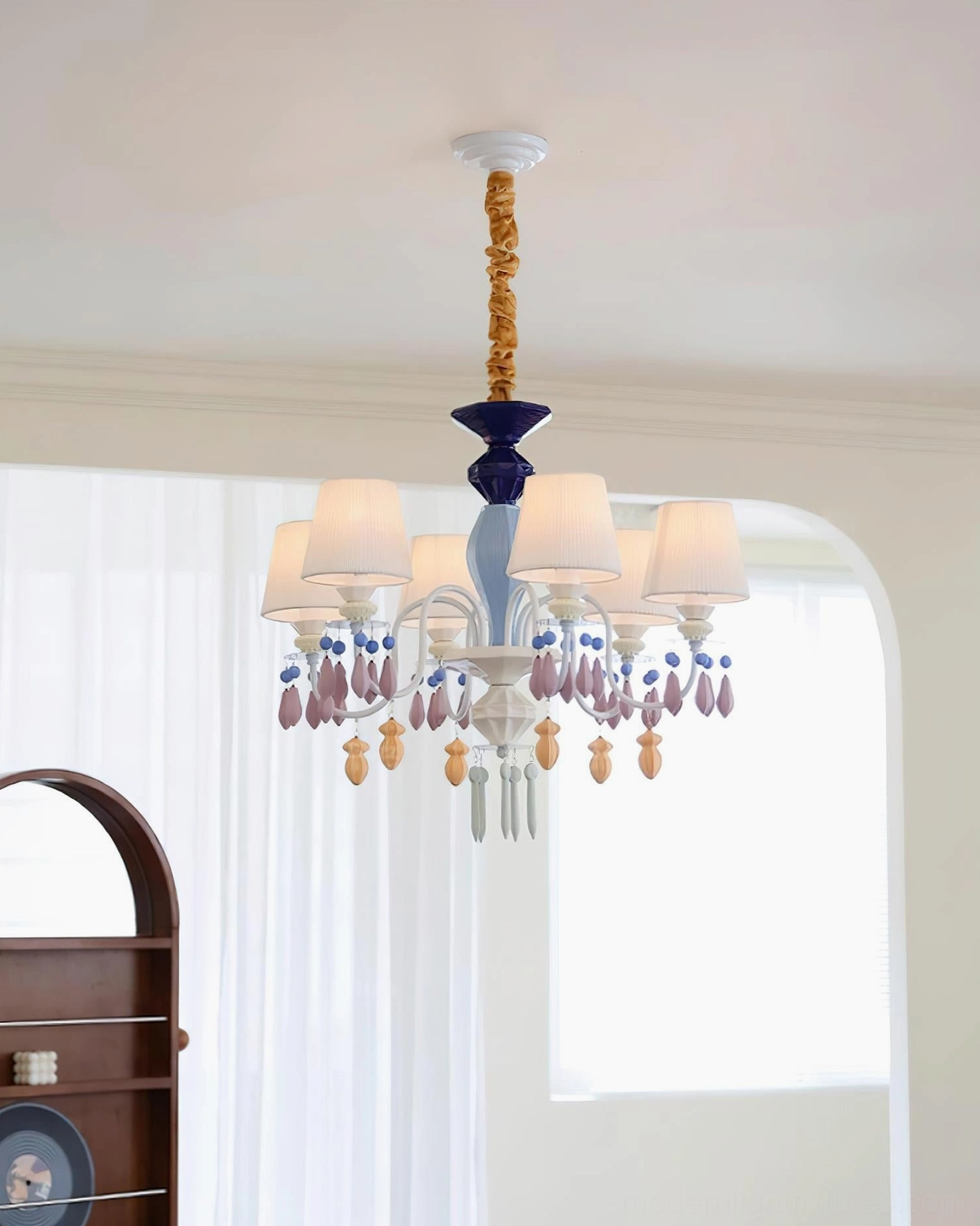 Overhead angle of multi-arm pastel ceramic chandelier showing lamp shade configuration and crystal accents
