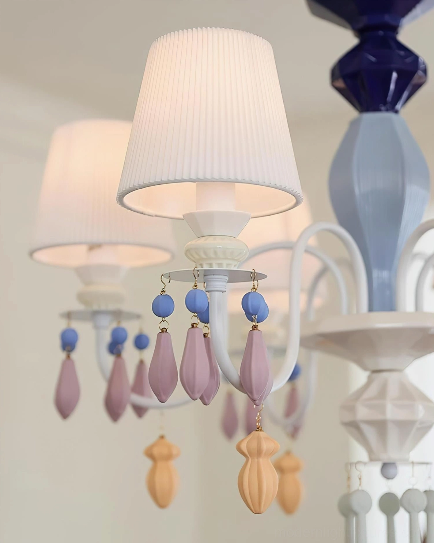 Close-up of ceramic chandelier pendants and bead details demonstrating craftsmanship and artistic design