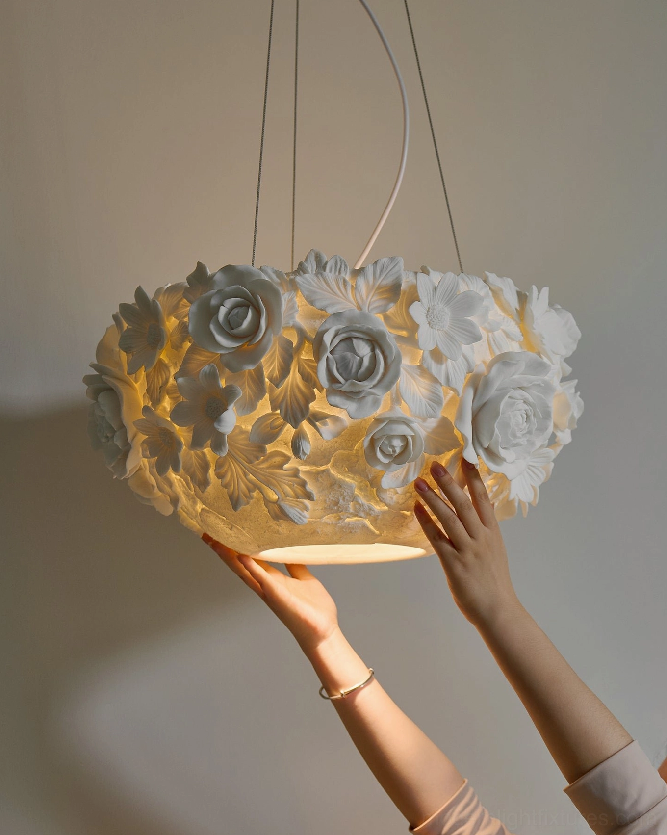 Ceramic floral pendant lamp creating ambient lighting in modern home interior, showing botanical design and finish quality