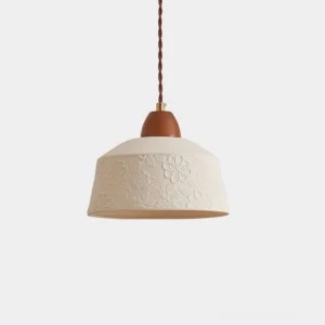 Ceramic floral embossed pendant lamp with walnut wood top, front studio view showing textured white shade