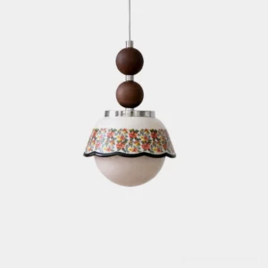 Bellora ceramic floral pendant light with walnut wood sphere accents and polished chrome metal fittings, front close-up view showing intricate scalloped floral pattern on glossy ceramic shade