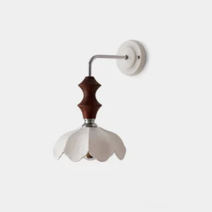 Ceramic floral wall sconce with white petaled shade, chrome arm, and walnut wood accent - studio front view