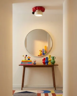 Ceramic berry cluster flush mount in modern entryway with round wall mirror and console table, playful retro home decor style