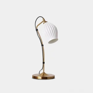 Modern ceramic gooseneck table lamp with brass finish and ribbed white shade, studio view showing left three-quarter perspective