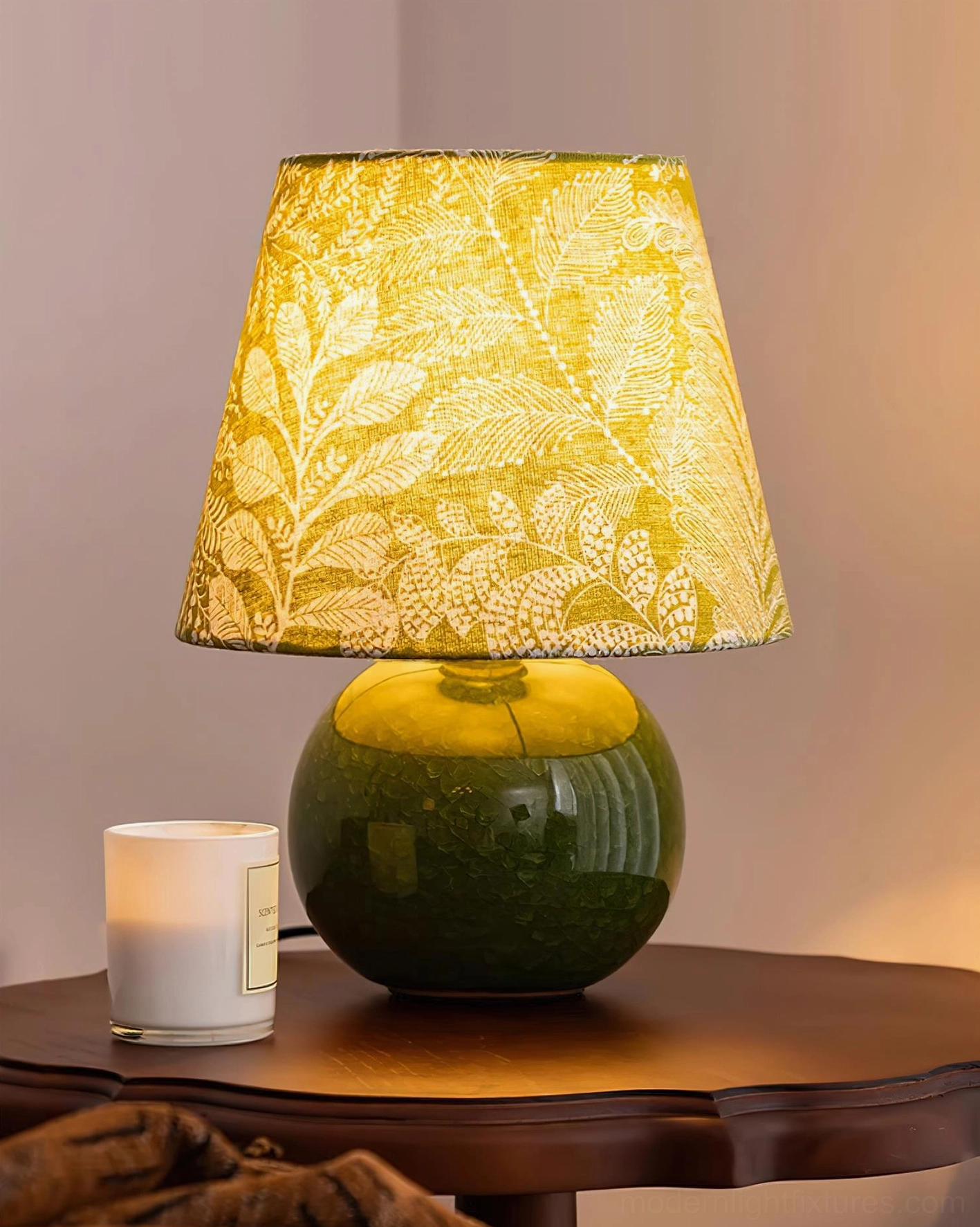 Ceramic green table lamp with intricate leaf pattern fabric shade product detail view