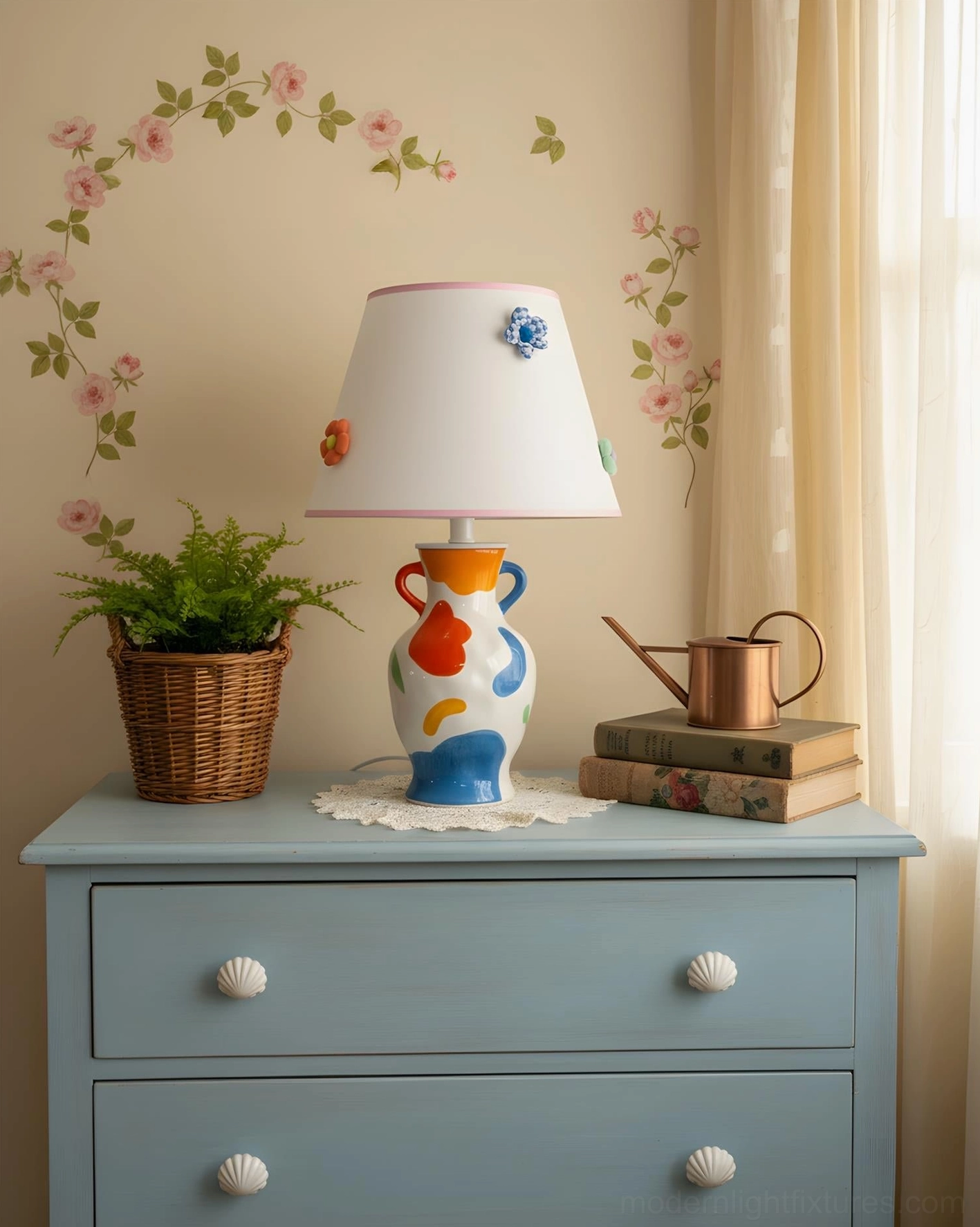 Hand-painted ceramic table lamp on vintage blue dresser in bedroom vanity area, paired with woven potted plant and decorative watering can