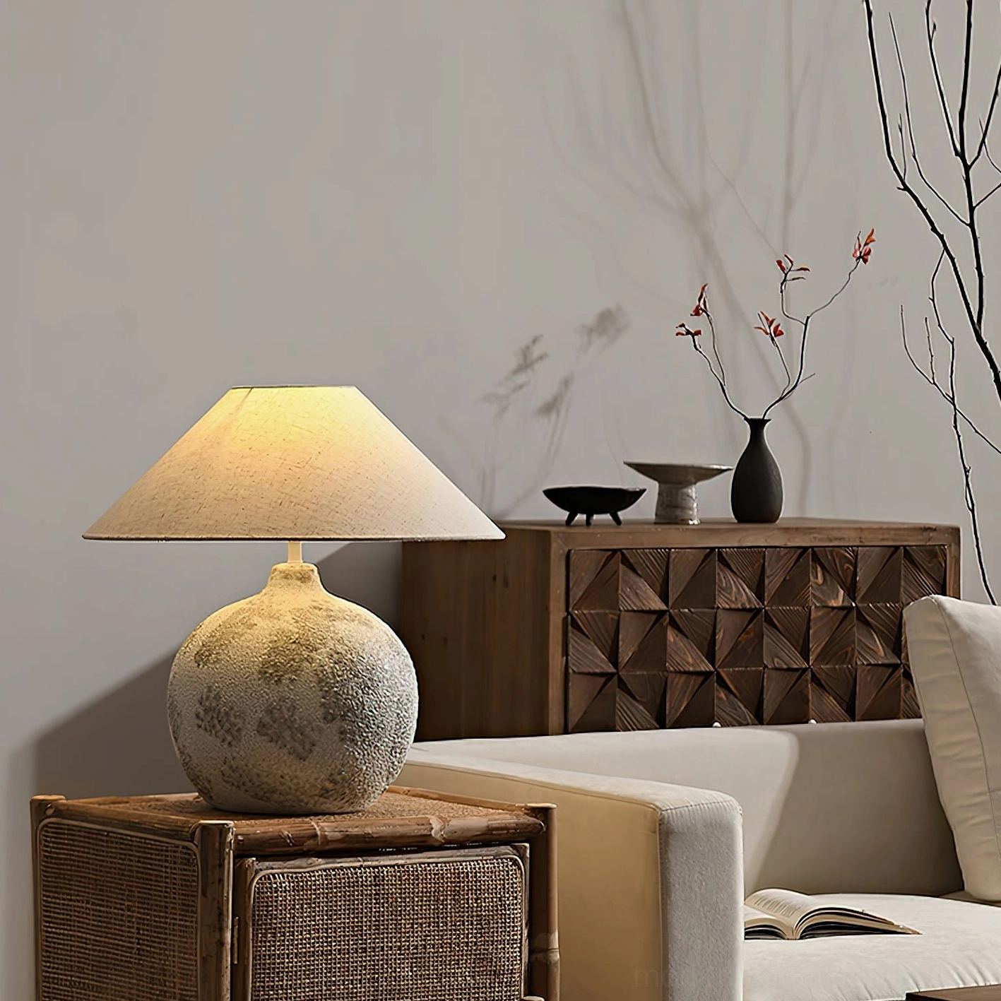 Modern ceramic table lamp positioned near wooden cabinet in cozy living room with minimalist flower arrangement and contemporary home decor