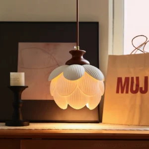 Warm-lit ceramic lotus pendant fixture in modern home decor setting, showing soft ambient glow from open petal design