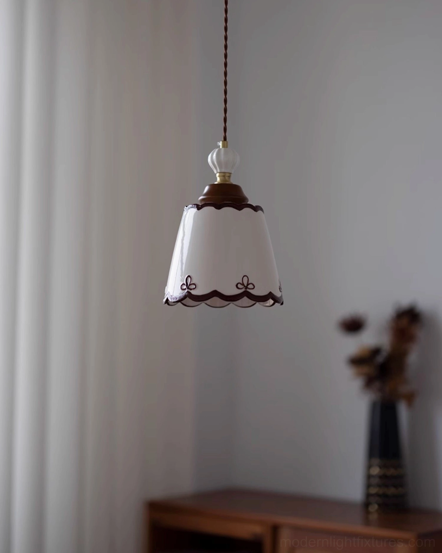 Ceramic pendant lamp creating warm ambient lighting in elegant transitional living space