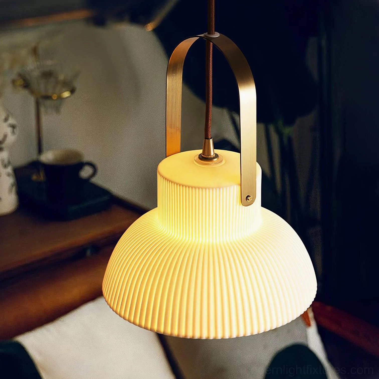 Ceramic pendant lamp with brass hanging mechanism in minimalist interior design