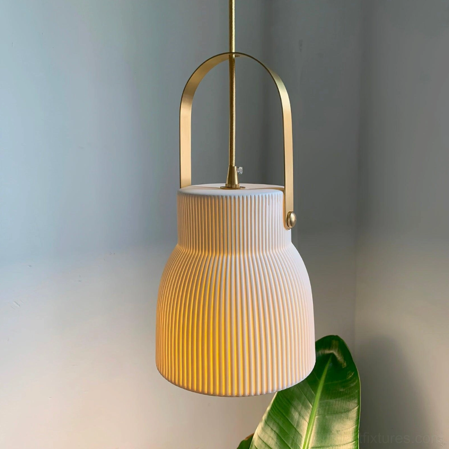 Close-up side view of large ribbed ceramic pendant lamp showing vertical texture and brass handle