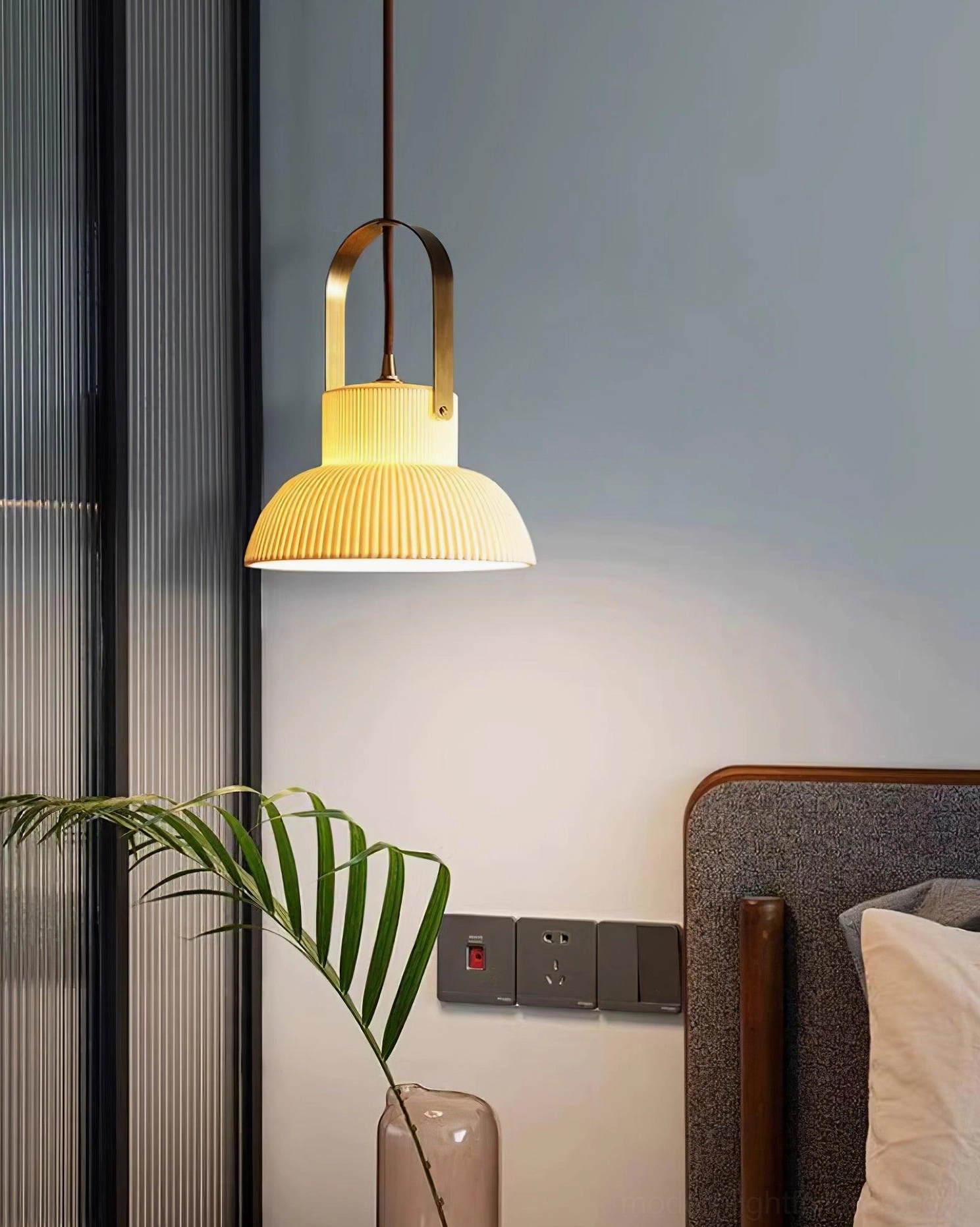 Modern ceramic pendant lamp with white shade and brass hardware in Japandi interior