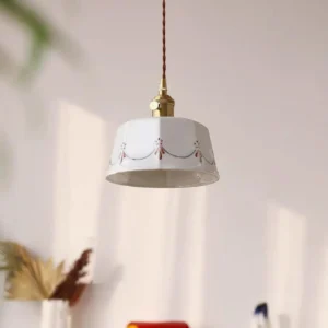 Eliana ceramic pendant lamp with gold brass hardware and intricate floral painting, overhead angle showing decorative shade interior