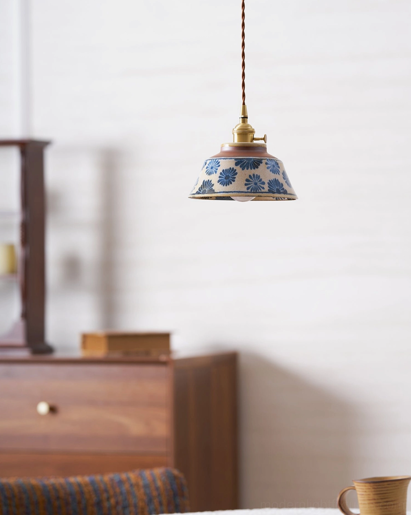 Hand-painted ceramic pendant light with candlelight layering for intimate room atmosphere