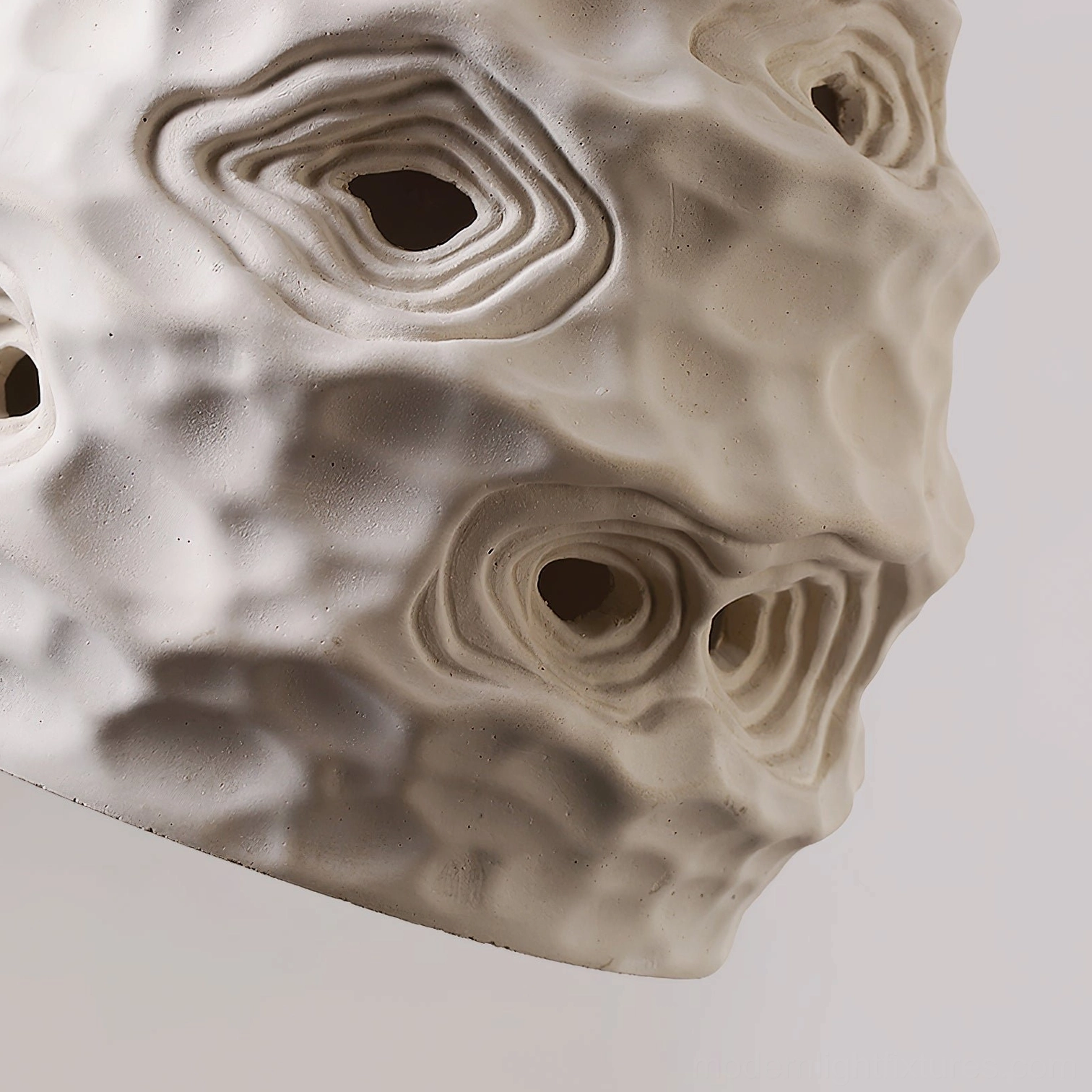 Organic ceramic pendant fixture in contemporary minimalist interior showing dimmer-compatible warm lighting control