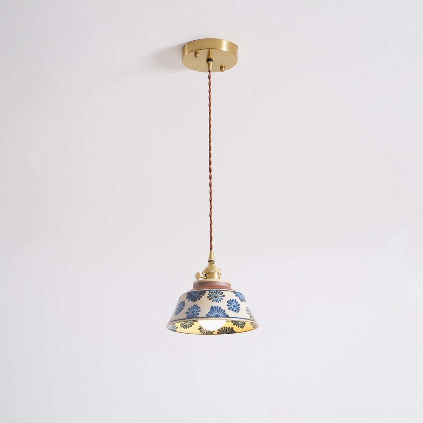 Evening interior photograph with ceramic pendant light illuminating space with warm glow