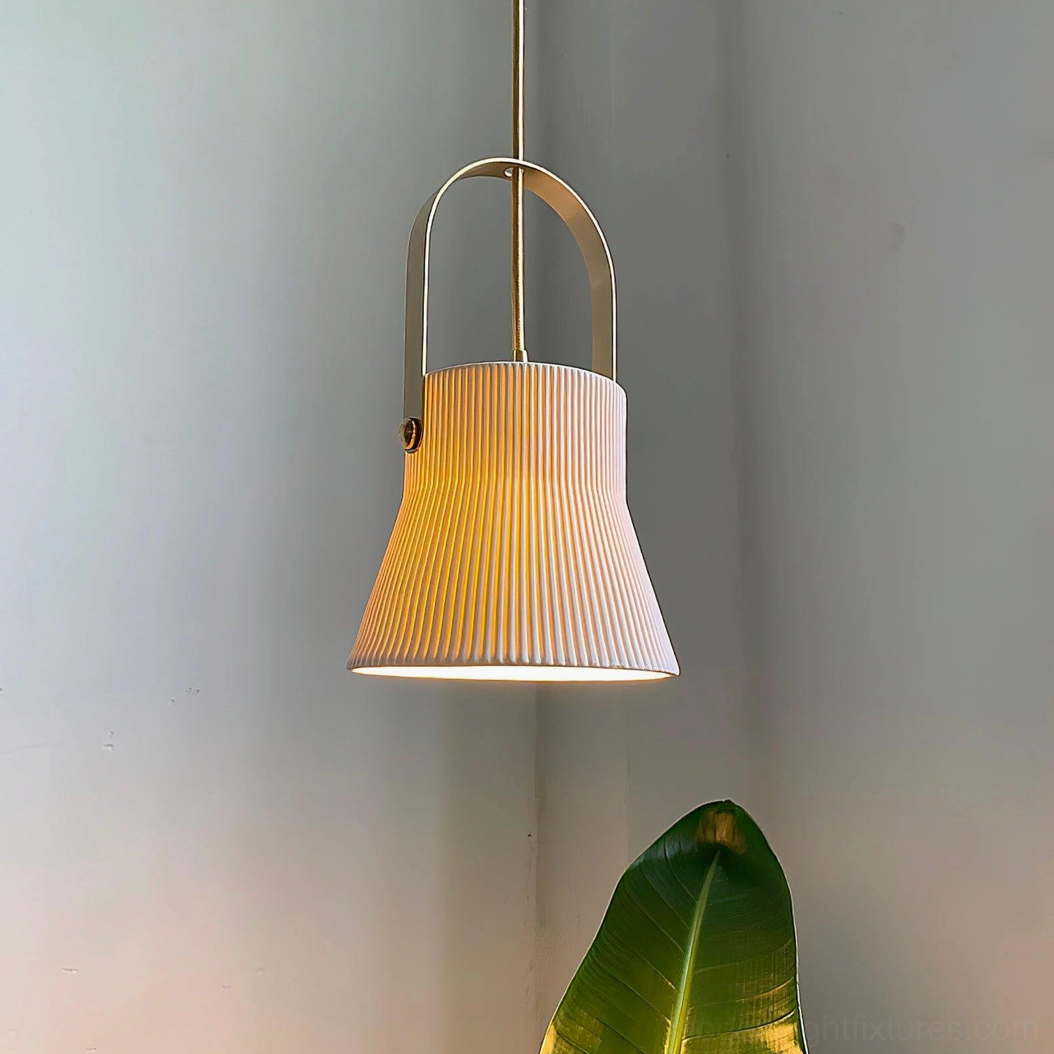 Single ceramic pendant lamp with ribbed texture installed in minimalist corner with green plants