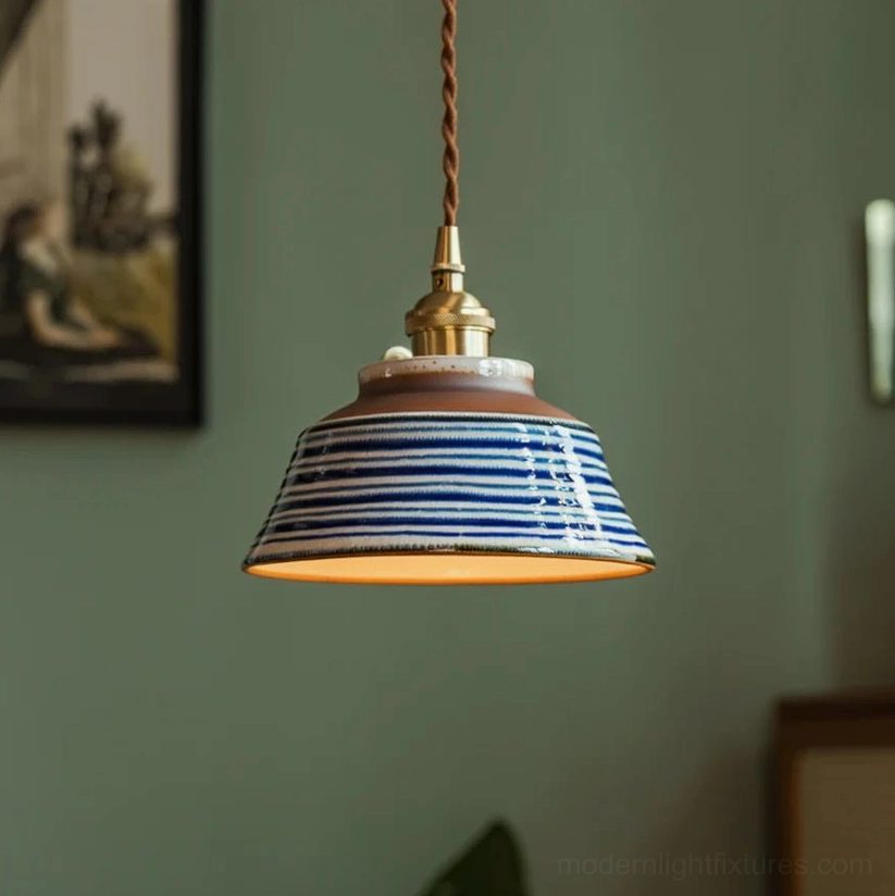 Hand-painted ceramic pendant light model E showing brass fixtures and blue floral decoration