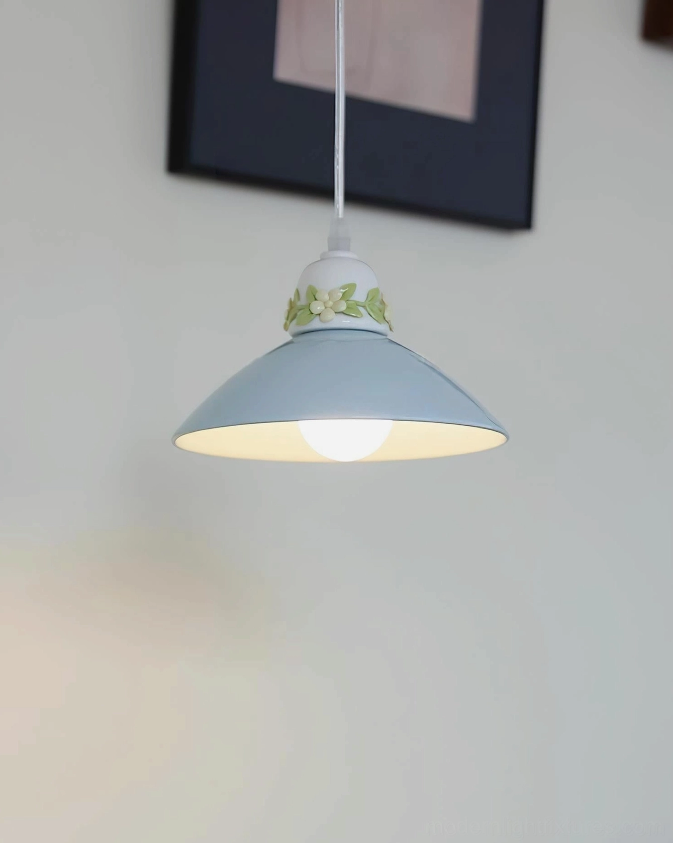 Hand-painted ceramic pendant light in modern minimalist dining room, sculptural white shade enhancing contemporary interior