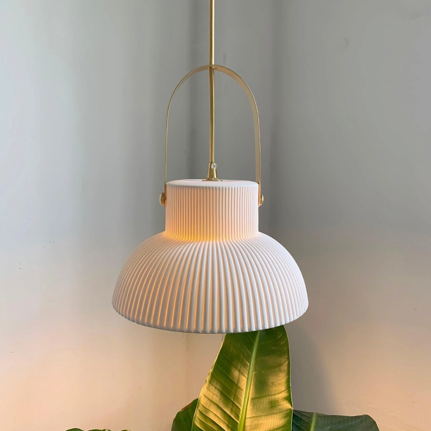 Ribbed ceramic pendant light displaying soft diffused illumination and sculptural form