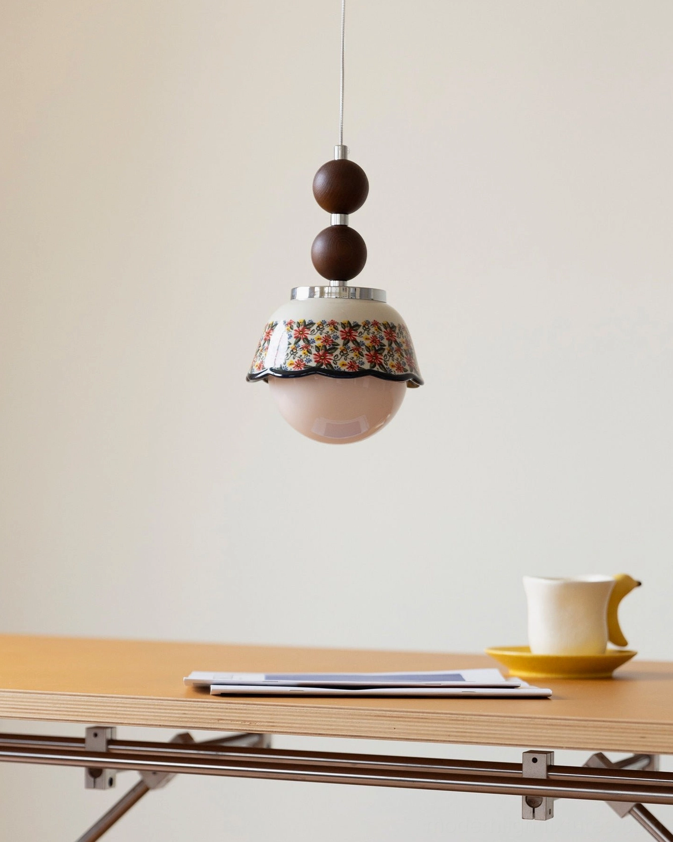 Ceramic pendant light with scalloped floral pattern shade, wood sphere bead accents, and chrome hardware for vintage-inspired modern interiors