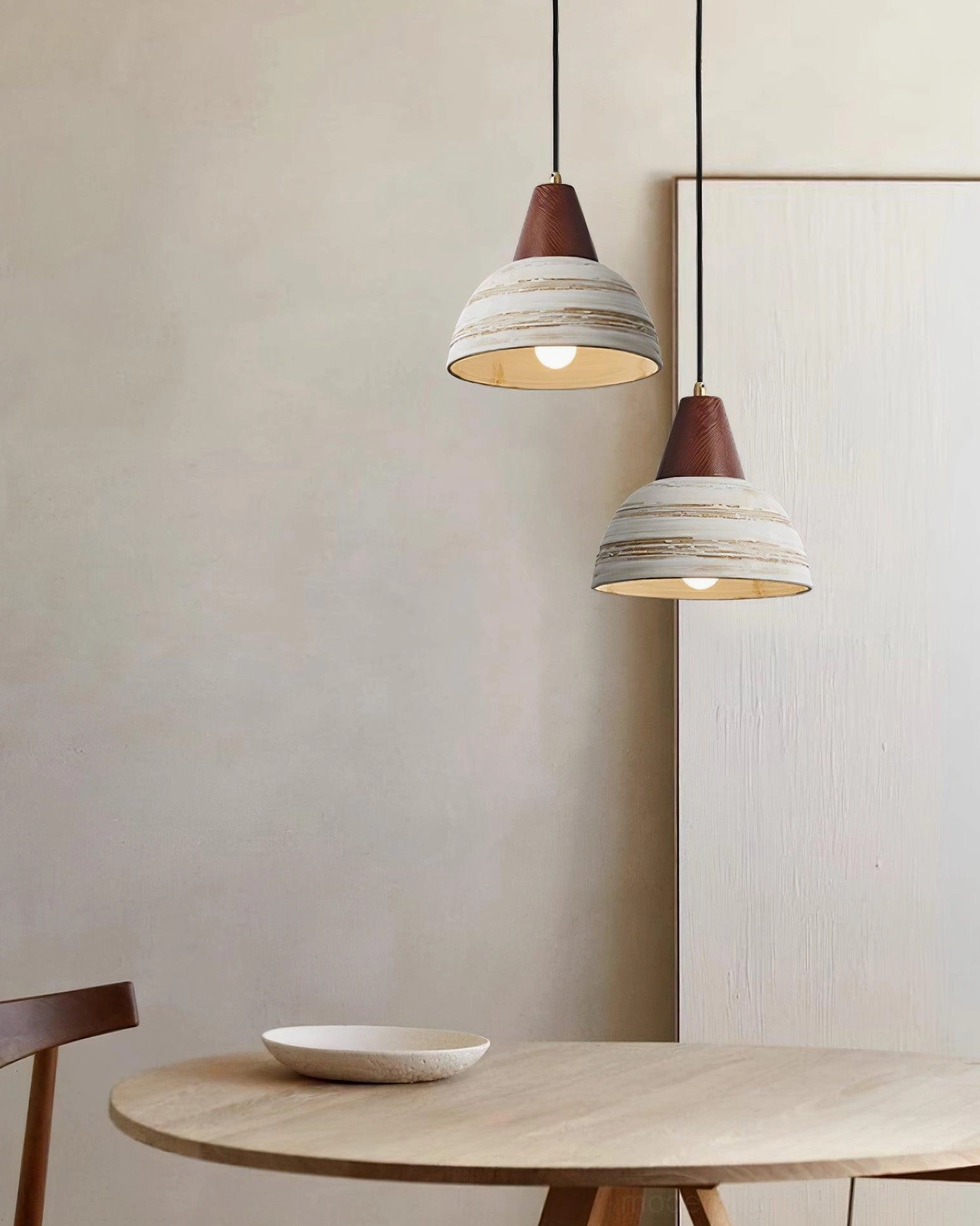 Ceramic pendant light with soft illumination creating warm atmospheric lighting in home interior