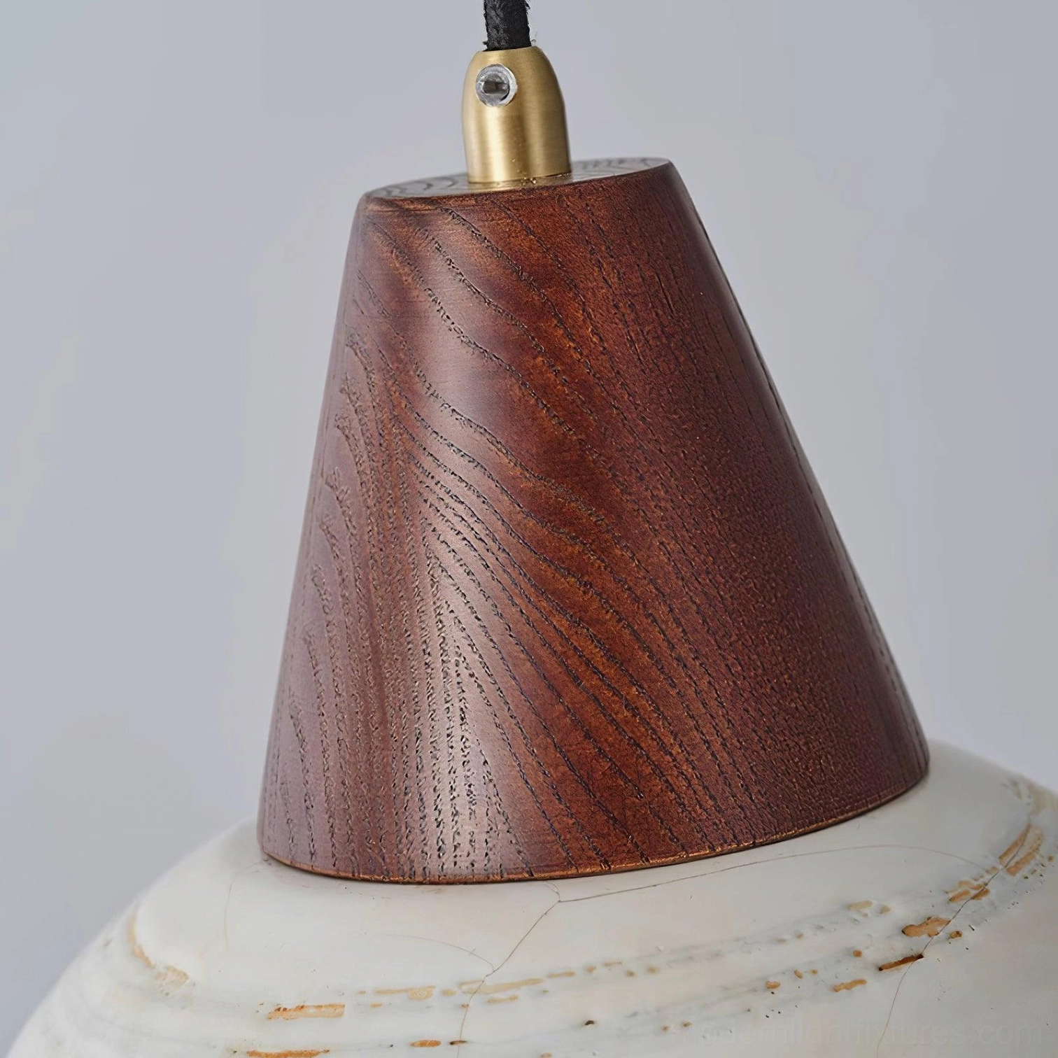 Modern ceramic pendant light fixture displaying warm glow through distressed handcrafted shade
