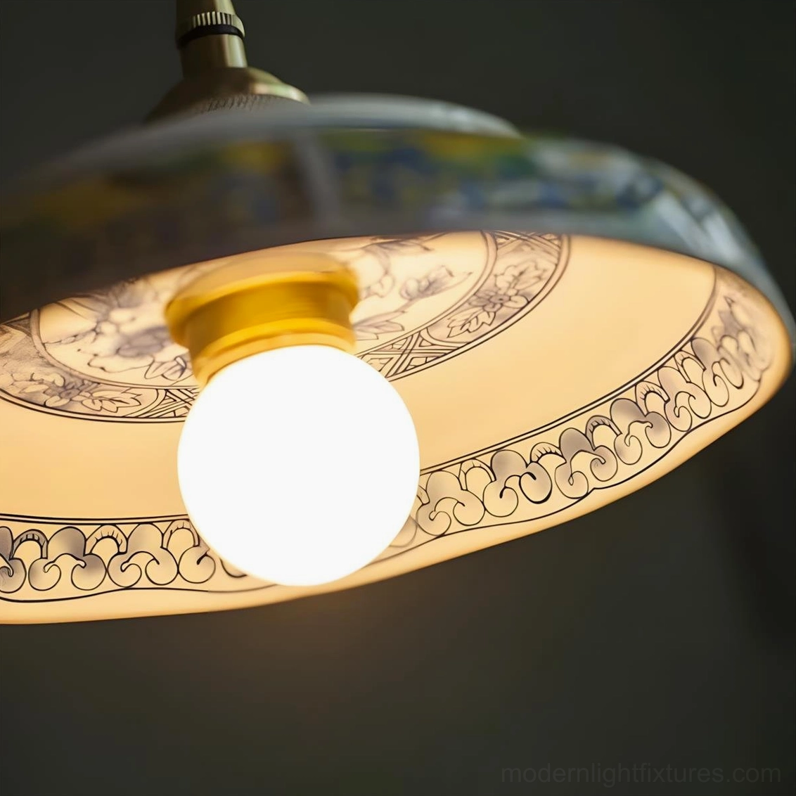 Clustered hand-painted ceramic saucer pendant lights hung over kitchen island creating layered ambient lighting