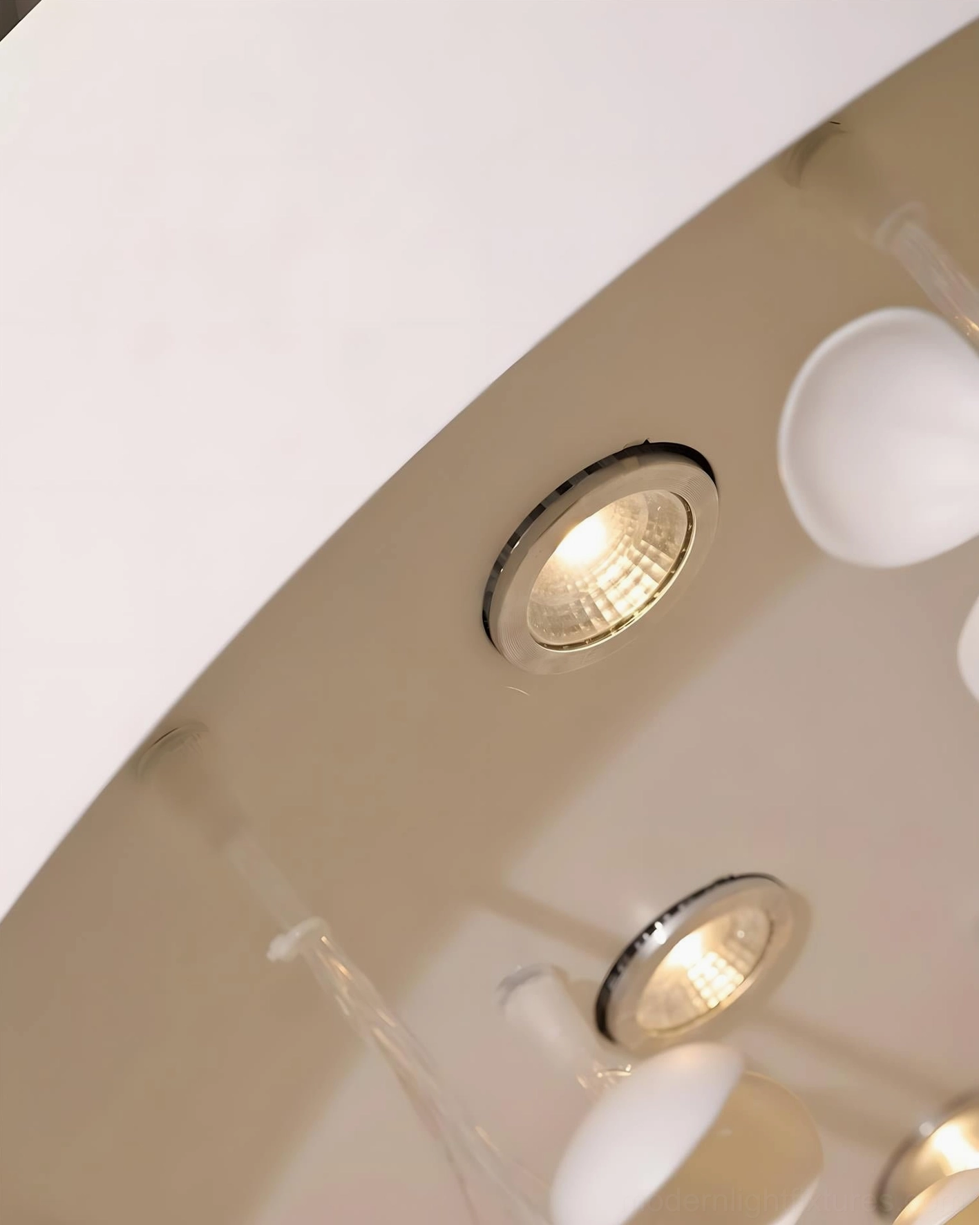 Ceiling mount detail of white ceramic petal chandelier showing metal recessed spotlights and installation base